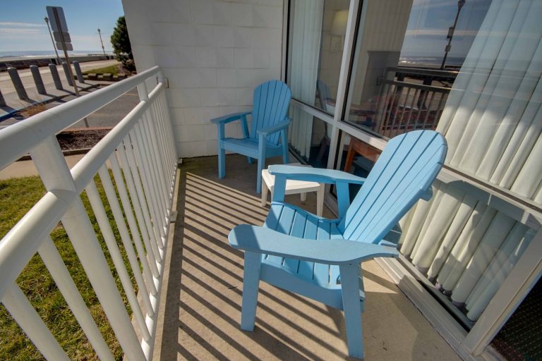 Sahara Motel balcony with two blue Adirondack chairs